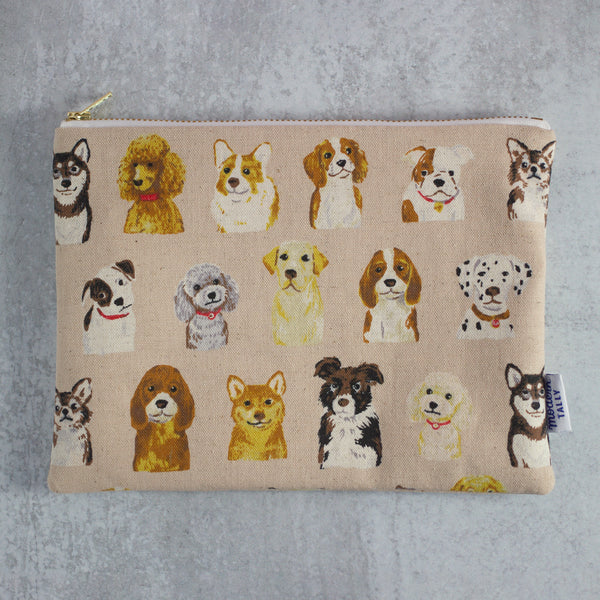 pale pink zipper pouch with a variety of dogs 